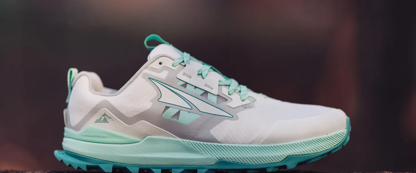 The Altra Lone Peak sits on a log.
