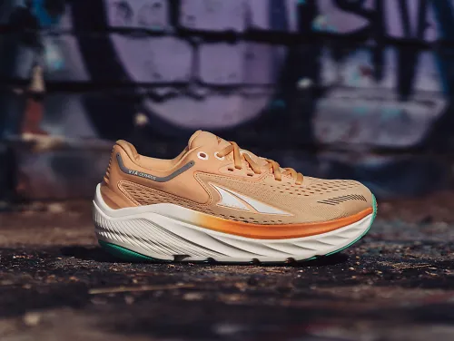 The women's Altra Via Olympus sits on the pavement.