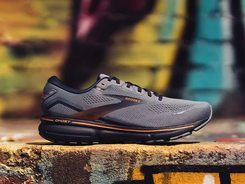 The Brooks Ghost 15 sits on a platform, giving a side profile view of the shoe.