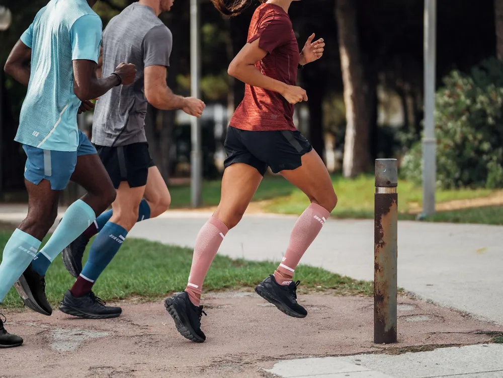 A group of runners wearing CEP socks.