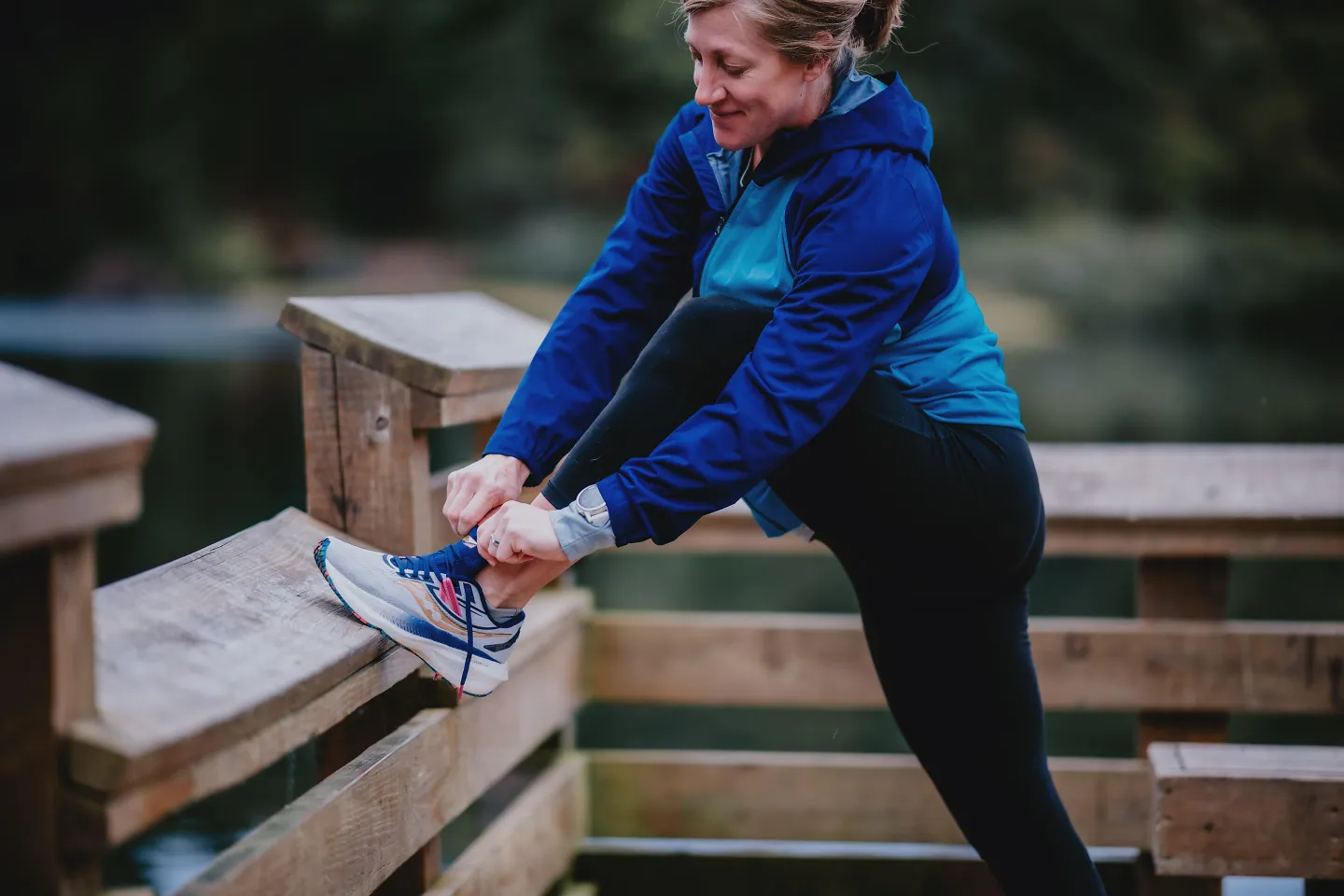 A woman stretches before starting her run.