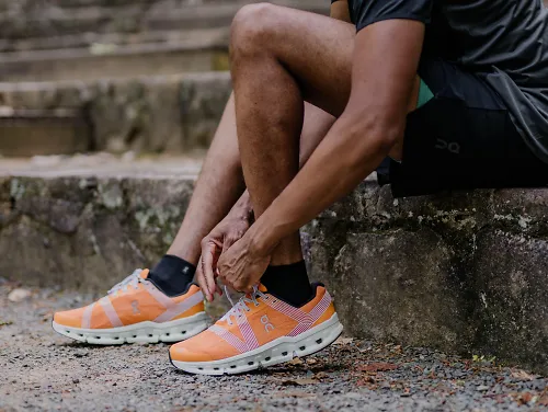 A man ties his running shoes.