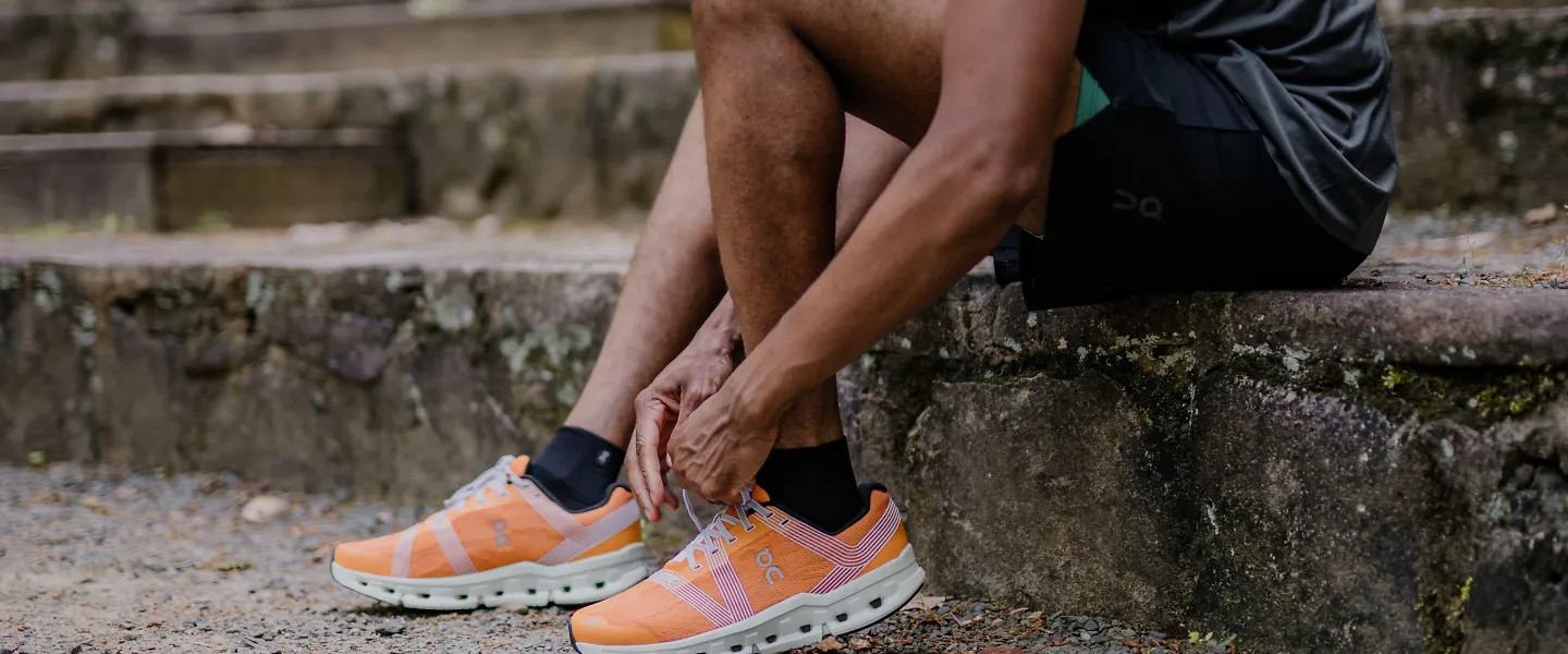 A man ties his running shoes.