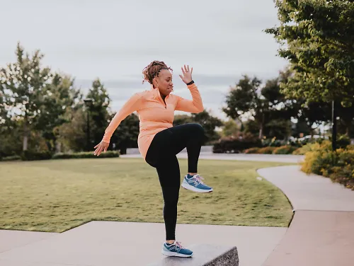A woman prepares for a cold run by warming up.