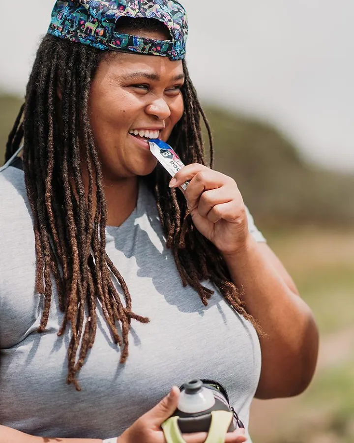 A woman eating an energy gel
