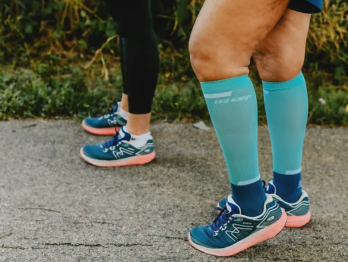 A runner wearing Karhu running shoes and compression socks.