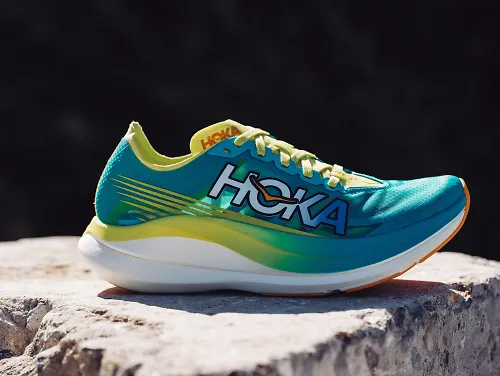 A pair of the HOKA Rocket X 2 sits on a rock, soaking up the sunlight.