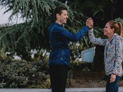 Two runners high five.
