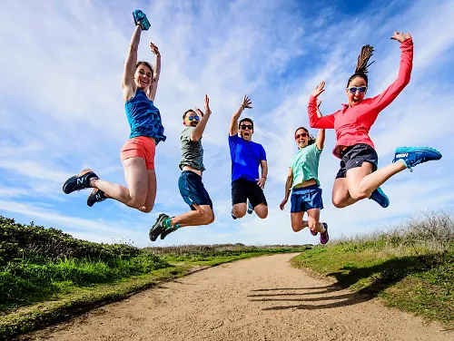 A group of runners jumps in the air together