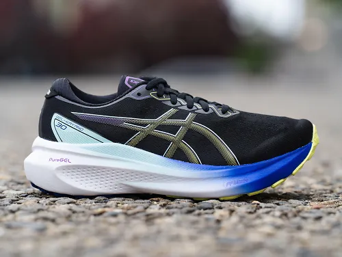 The new ASICS GEL-Kayano 30 sits on the pavement.