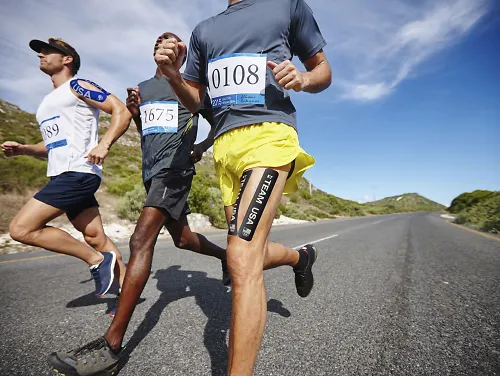 A group of runners wearing kinesiotape.