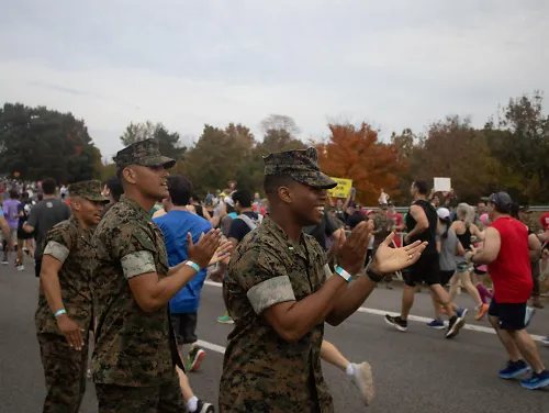 Marines cheer on runners during the 2023 Marine Corps Marathon.
