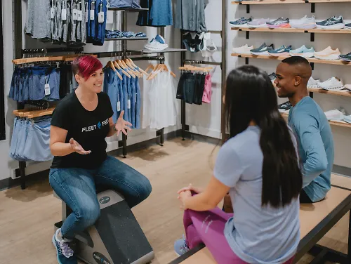 A Fleet Feet outfitter talks to customers. 