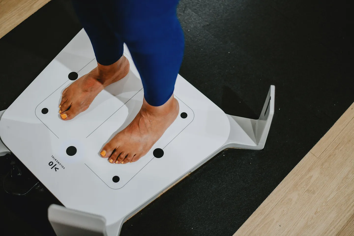 A woman stands on a fit id scanner.