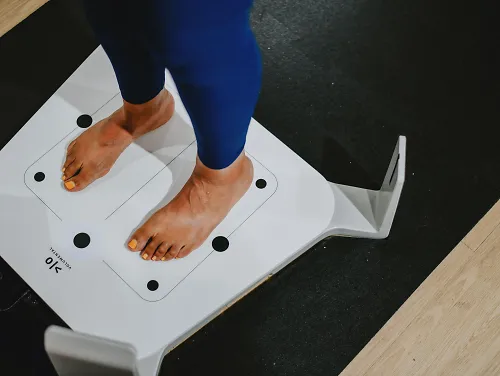 A woman stands on a fit id scanner.