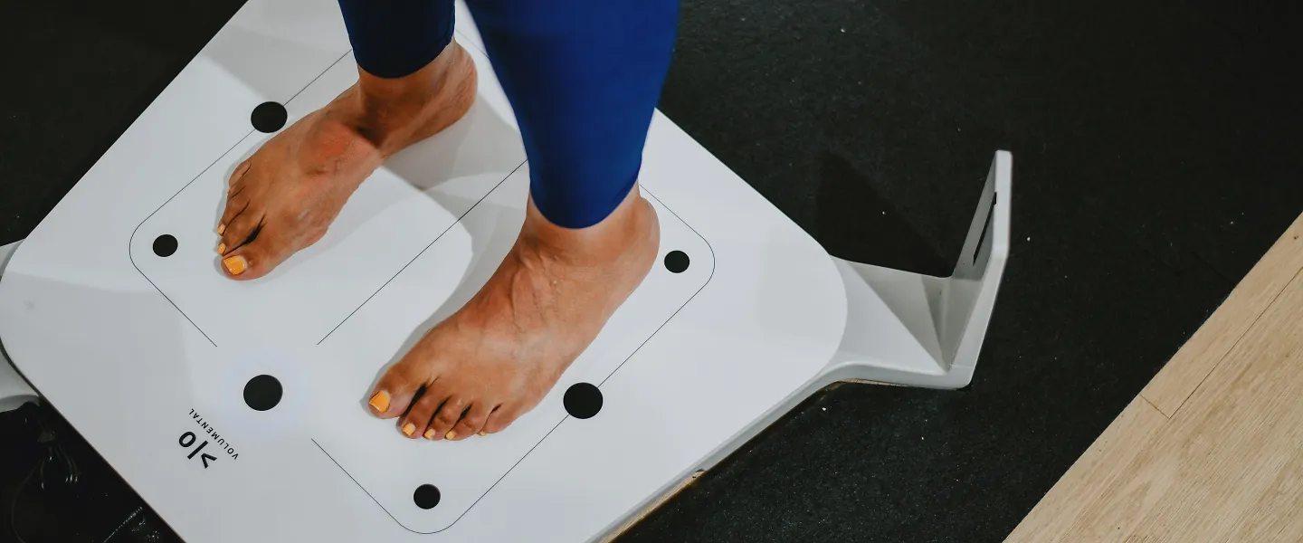 A woman stands on a fit id scanner.