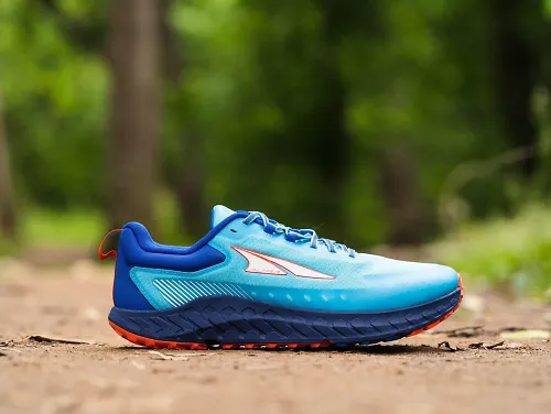 The men's Altra Outroad sits on a wooded trail.