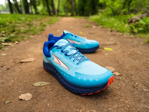 A pair of the men's Altra Outroad 2 sits on a sandy trail.