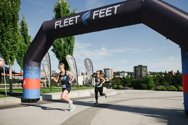 Runners cross the line at a Fleet Feet race.
