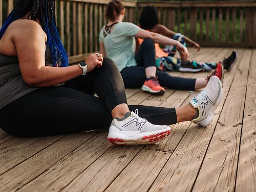 Runners stretch together after a run.