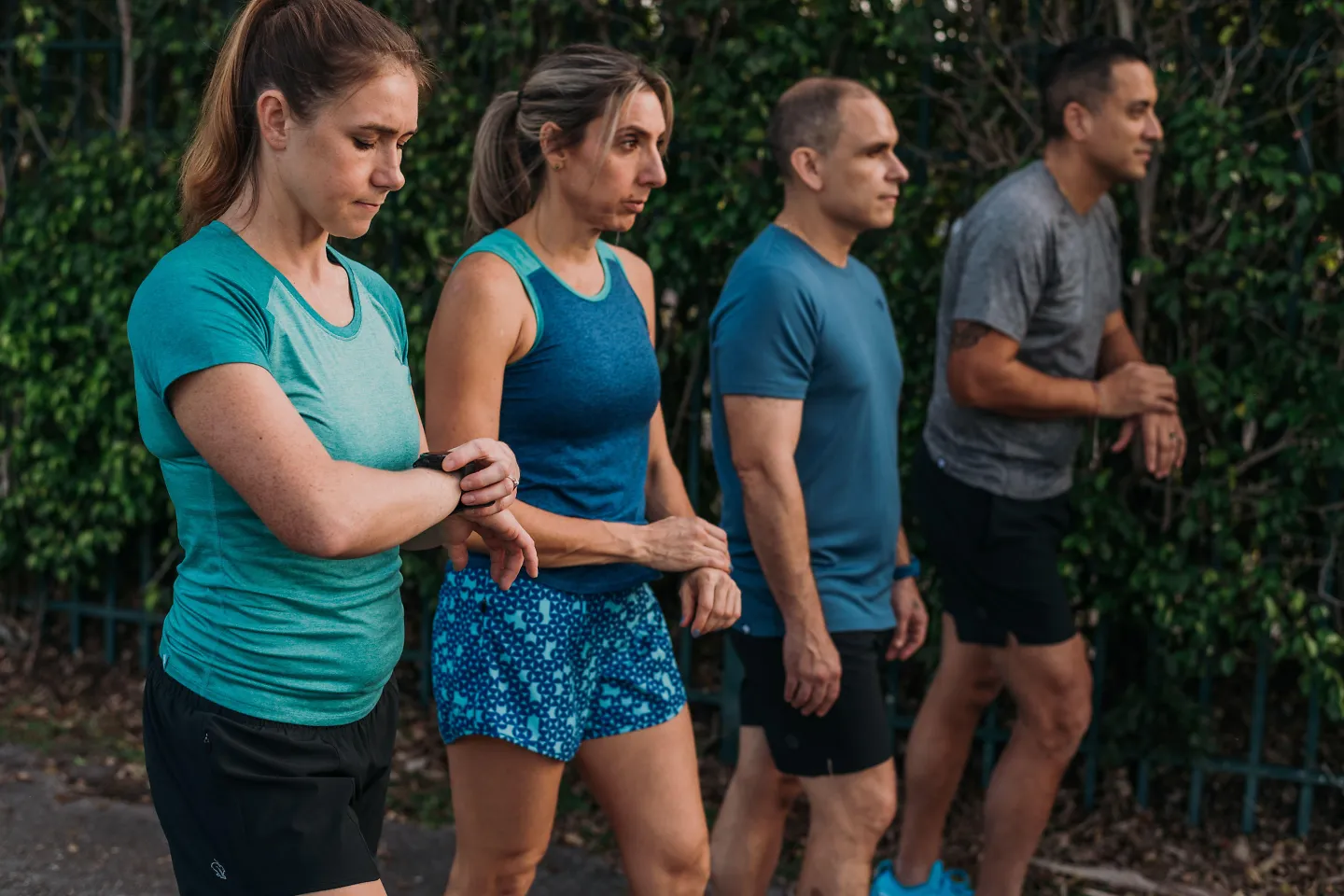 Runners prepare their Garmin watches before a run.