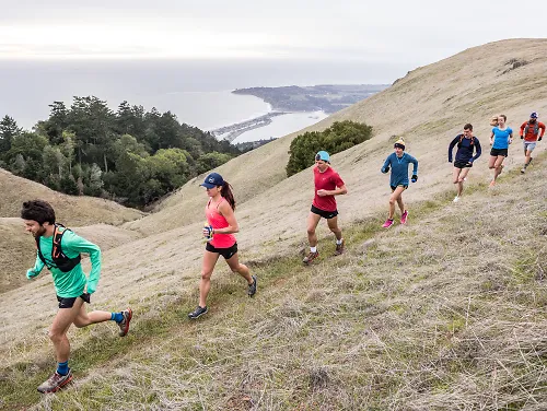 Group of people trail running on a ridge