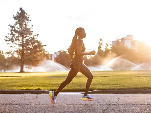 A woman runs during golden hour.