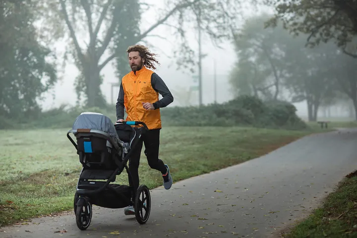 A dad running with a jogging stroller