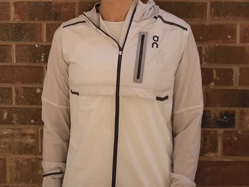 A woman wearing the On Weather Jacket in white