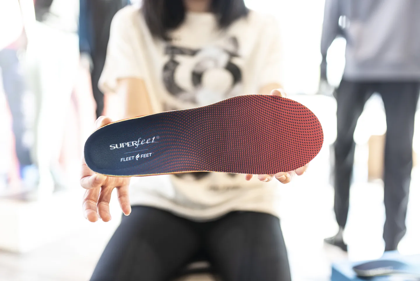 A person holding a Superfeet insole, perfect gifts for runners