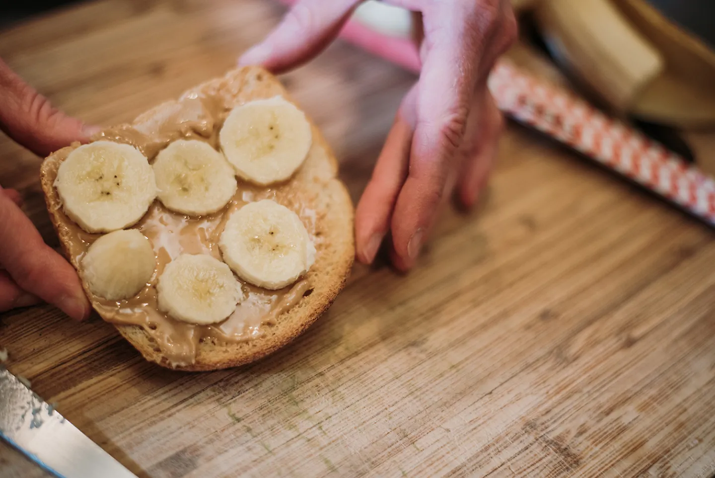A piece of bread topped with peanut butter and sliced banana.