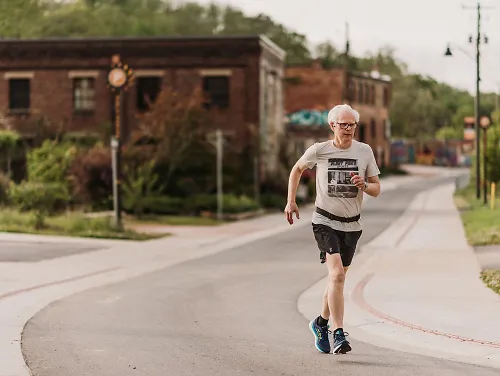 A man runs down the road.