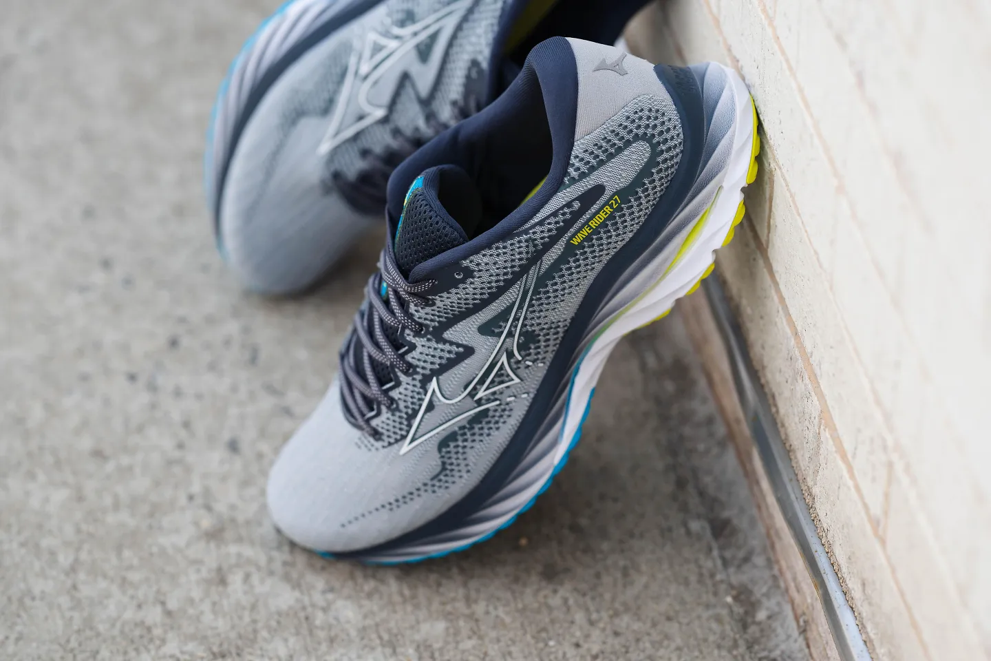 a pair of Mizuno Wave Riders on a sidewalk