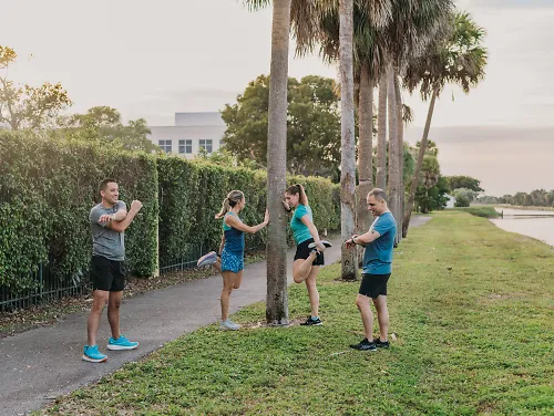 A group of runners stretch before their run.