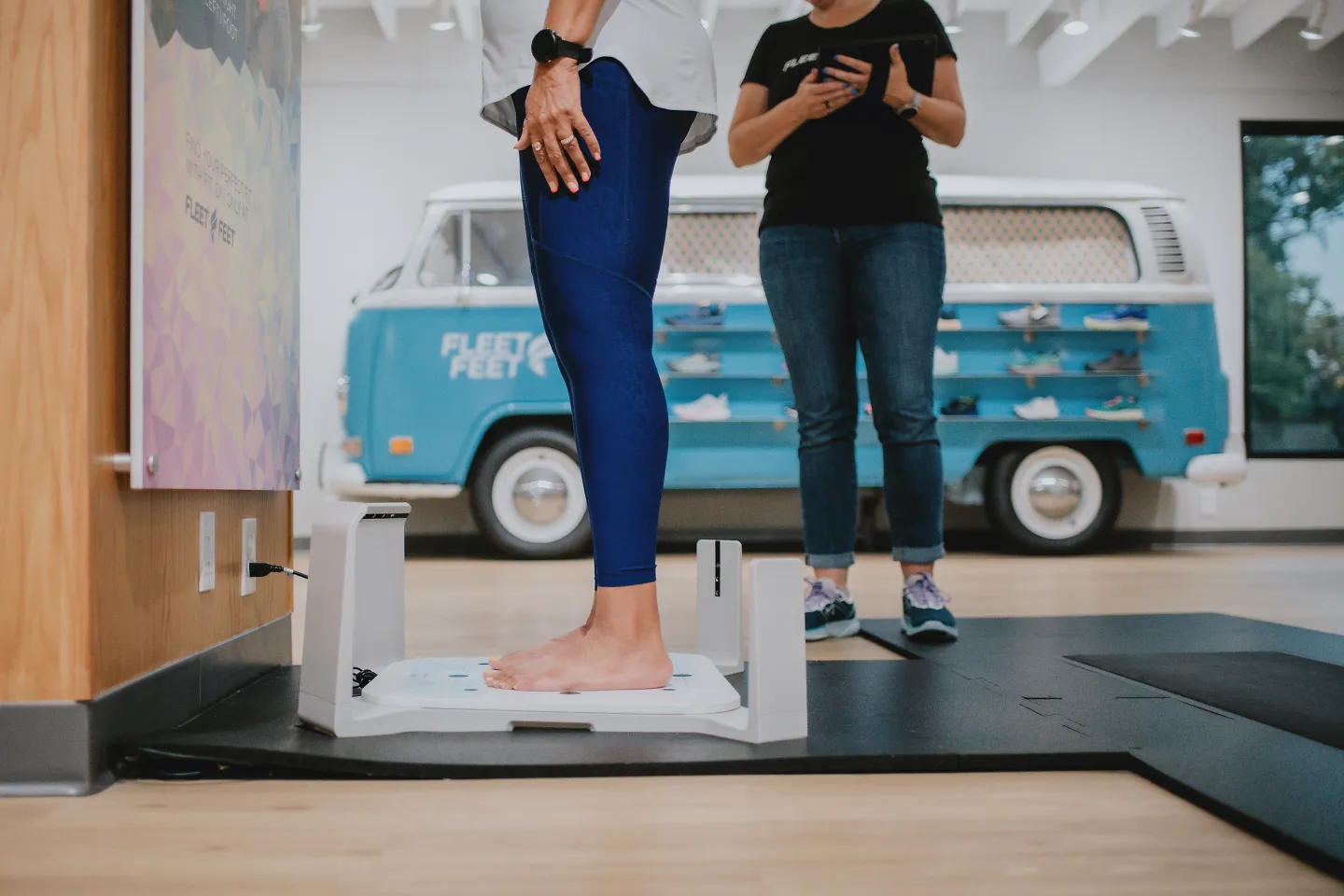A woman stands on the 3D scanner at Fleet Feet. 