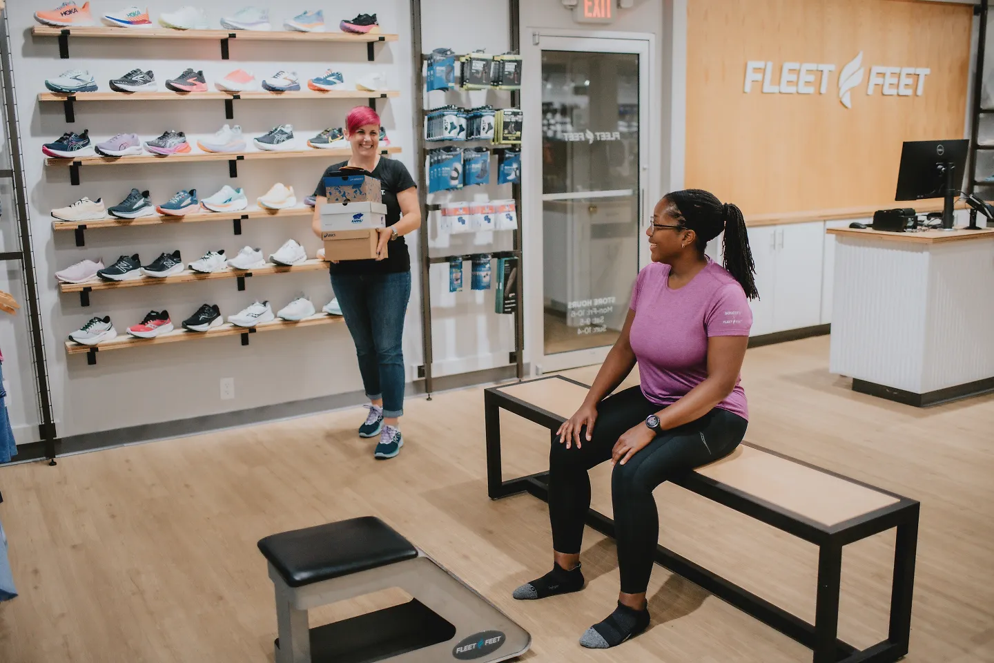 A Fleet Feet outfitter brings out a few boxes of shoes.