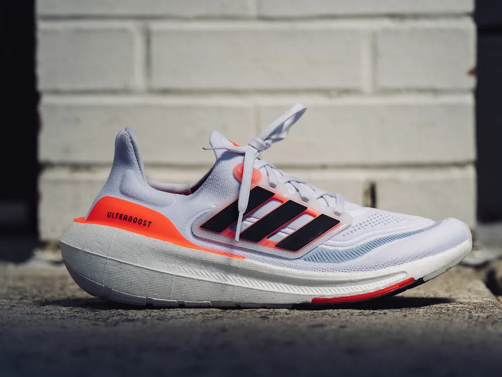A men's Adidas Ultraboost sits sideways in front of the camera. 
