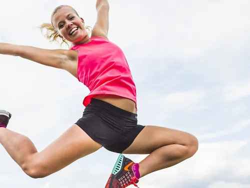 A running jumping in the air in celebration