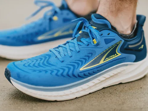 a pair of blue Altra Torin 7s on the ground