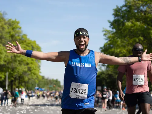 Antonio Quinones grins and extends his arms as he runs