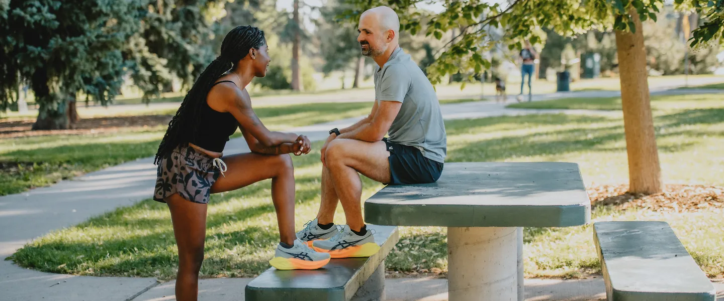 A man and woman chat before a run. 