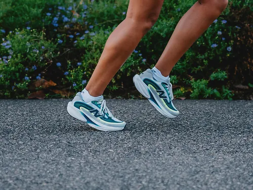 Runner's leg mid-stride wear New Balance Ellipse v1 running shoes