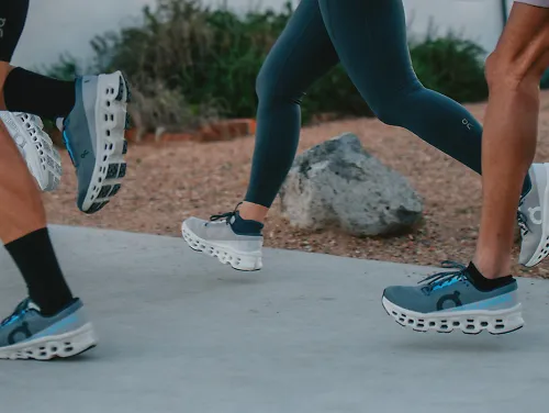 Close up of group of runners wearing On Cloudmonster 3 running shoes