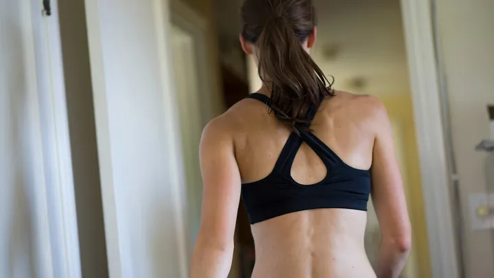 A woman wearing a pullover sports bra
