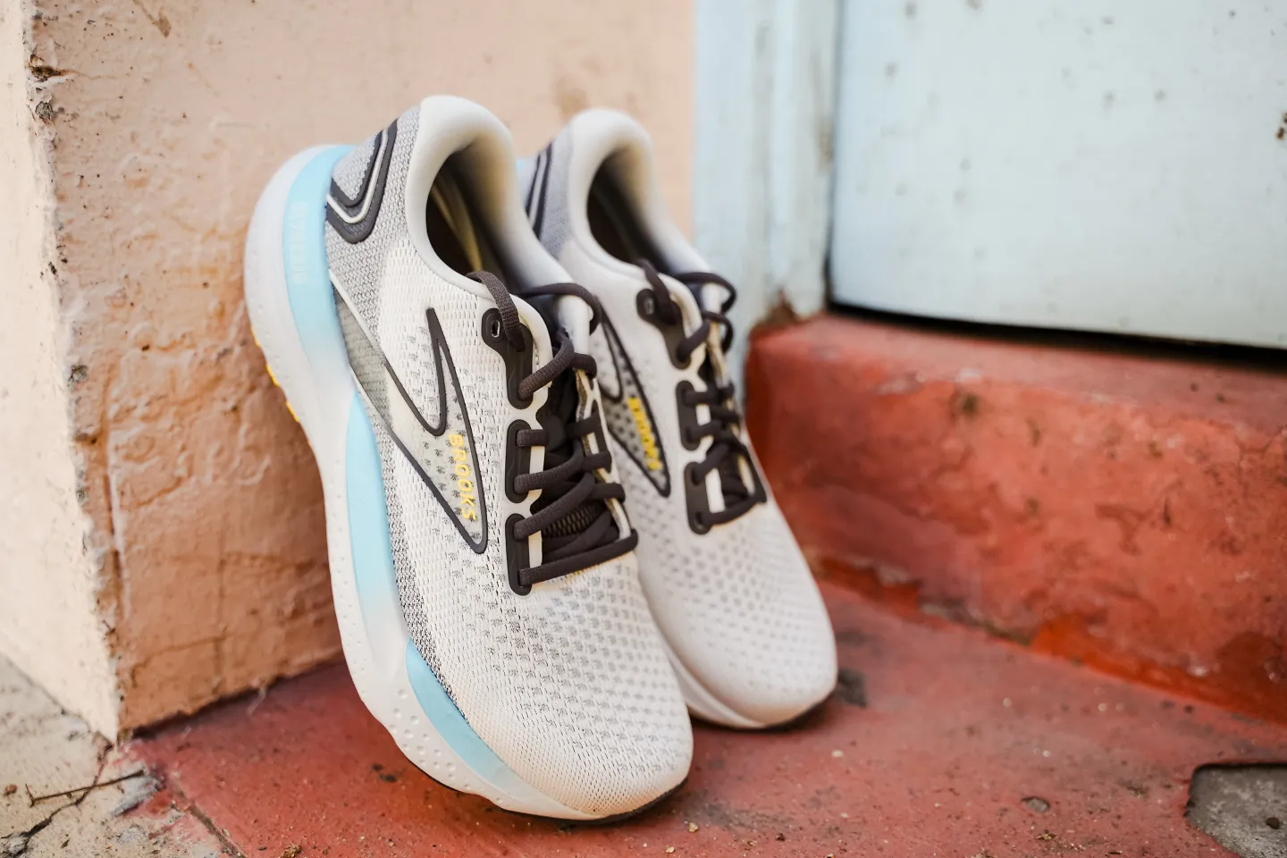 A pair of Brooks Glycerin resting up against the wall of an entryway