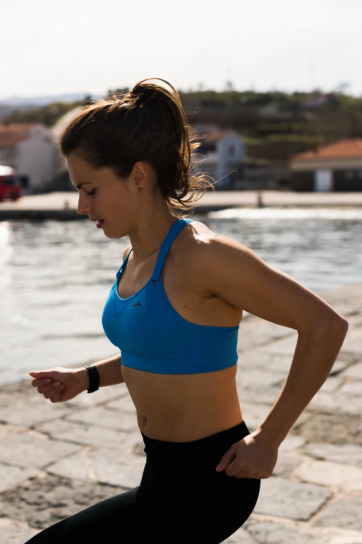 A woman wearing a Brooks Rebound Race sports bra
