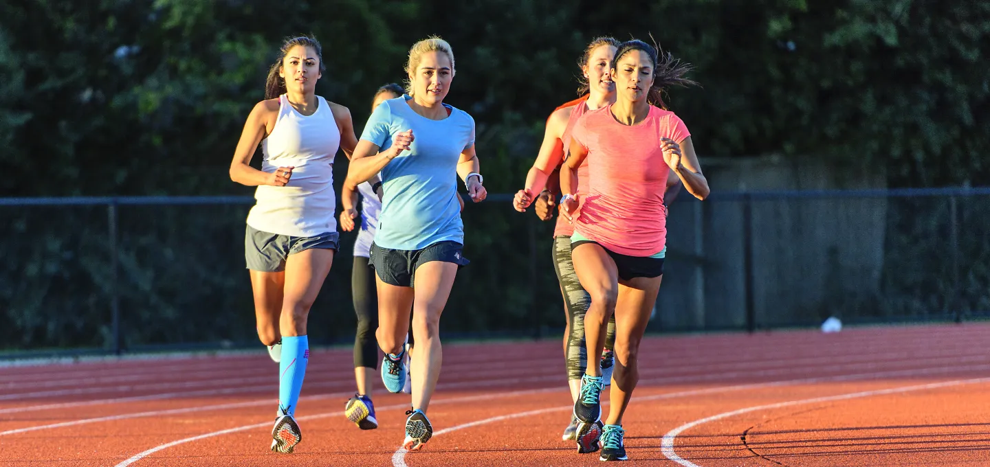 Three runners running on a track