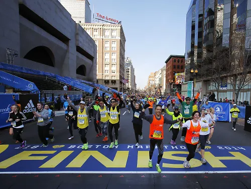 Runners crossing the finish line of the 2014 Boston Marathon