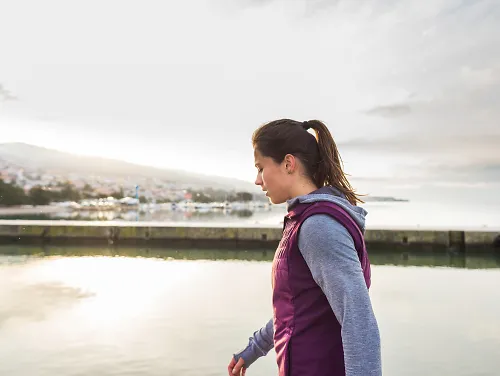 A woman wearing warm running clothes during a cold day