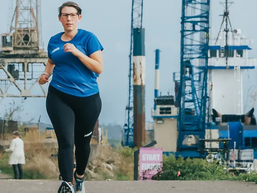Libby Mongue-Wymore runs in an urban setting
